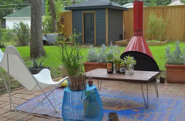 smart patio ideas backyard-patio-design-with-red-fireplace-and-blue-rug