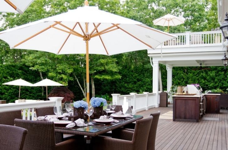 smart patio ideas dark-wood-outdoor-kitchen-with-white-garden-umbrella