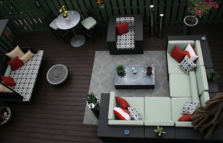 smart patio ideas modern-patio-furniture-arrangement-wooden-flooring-l-shaped-sofa-light-blue-rug-red-cushions