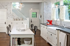beautiful cottage kitchen with traditional pendant light and white brick wall