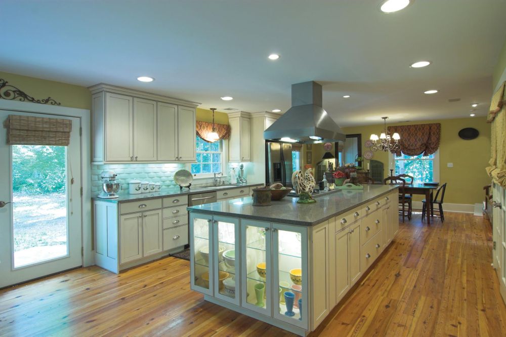 elegant spacious kitchen design with over cabinet light and wide top kitchen island plus kitchen hood
