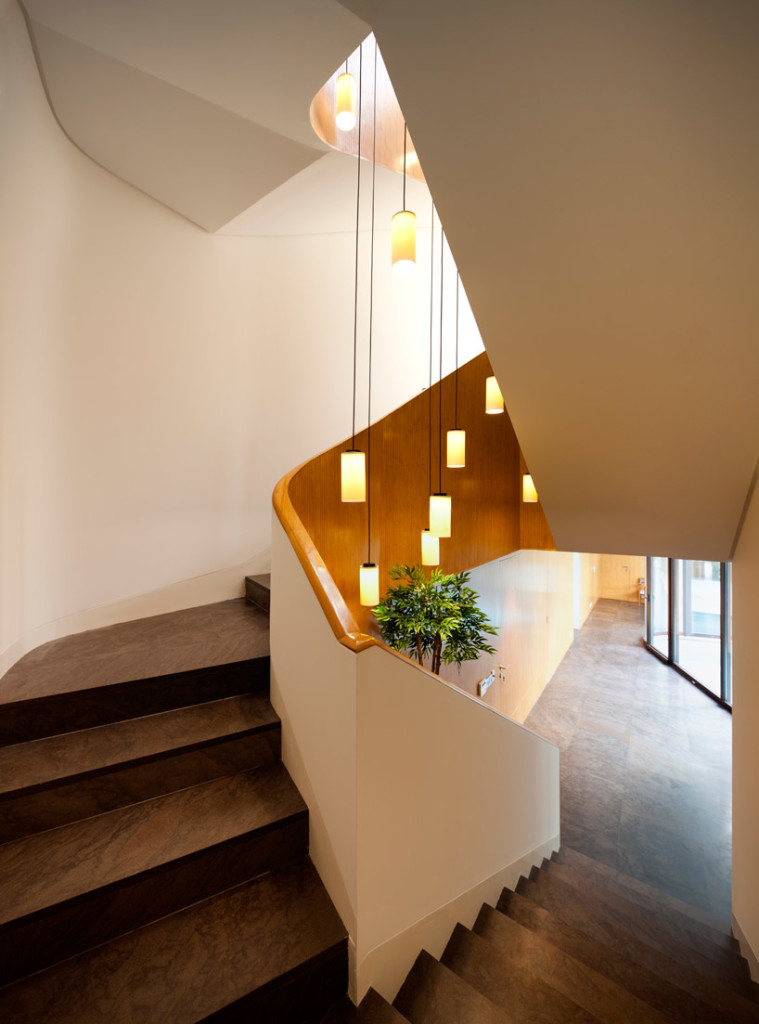 Captivating Stairwell Lighting for The Stylish Spiral Staircase with Luminous Brown White Pendant Lamps plus Long Black Filaments