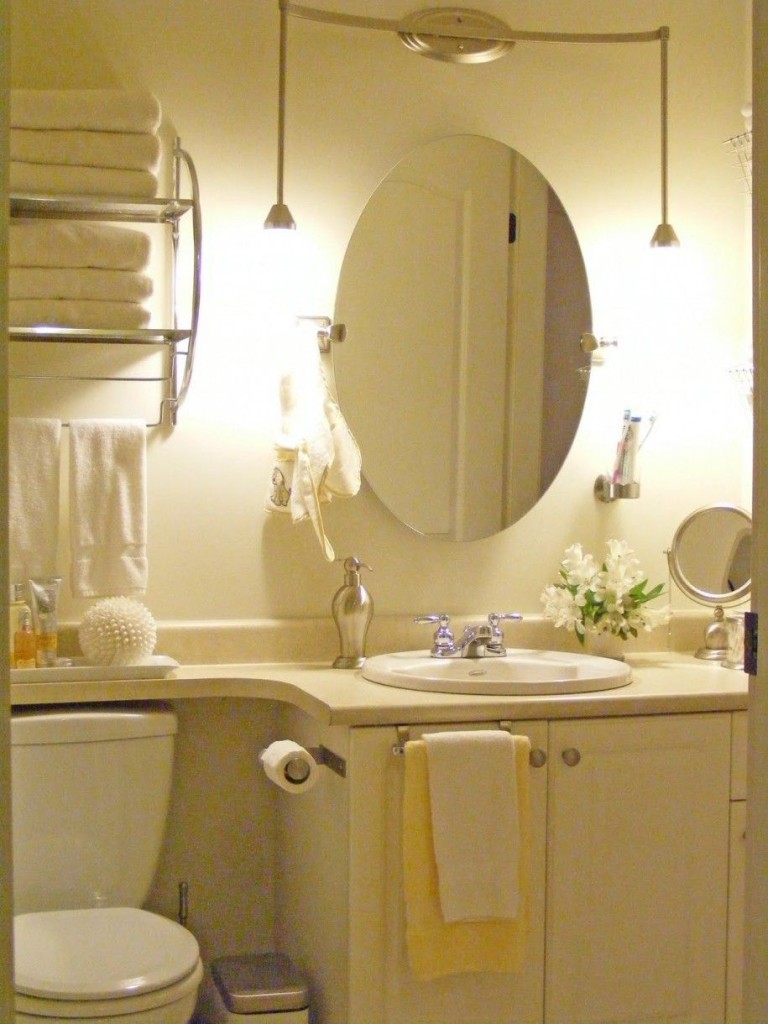 Adorable Oval Mirror in The White Scheme Bathroom Design with Wall Lamps