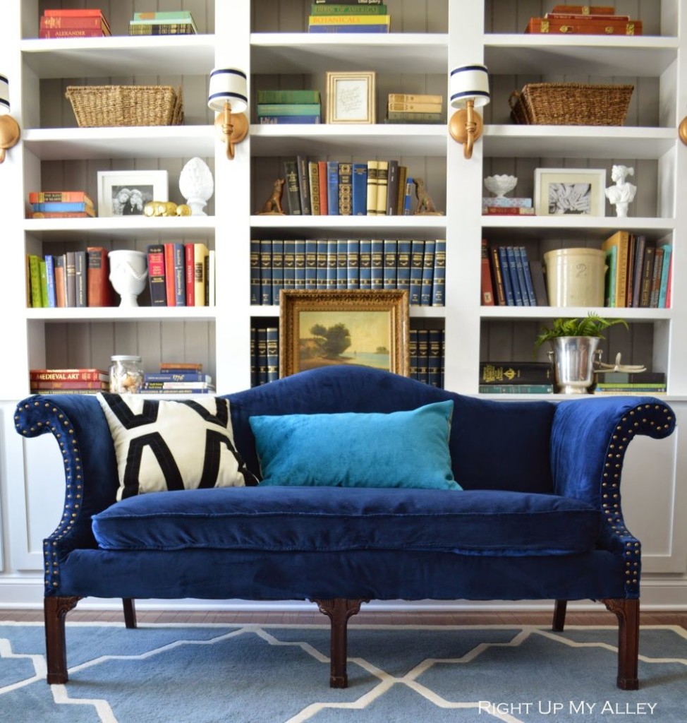 Appealing Navy Blue Velvet Camel Sofa with Enchanting Cushions and The High Dark Brown Wooden Legs